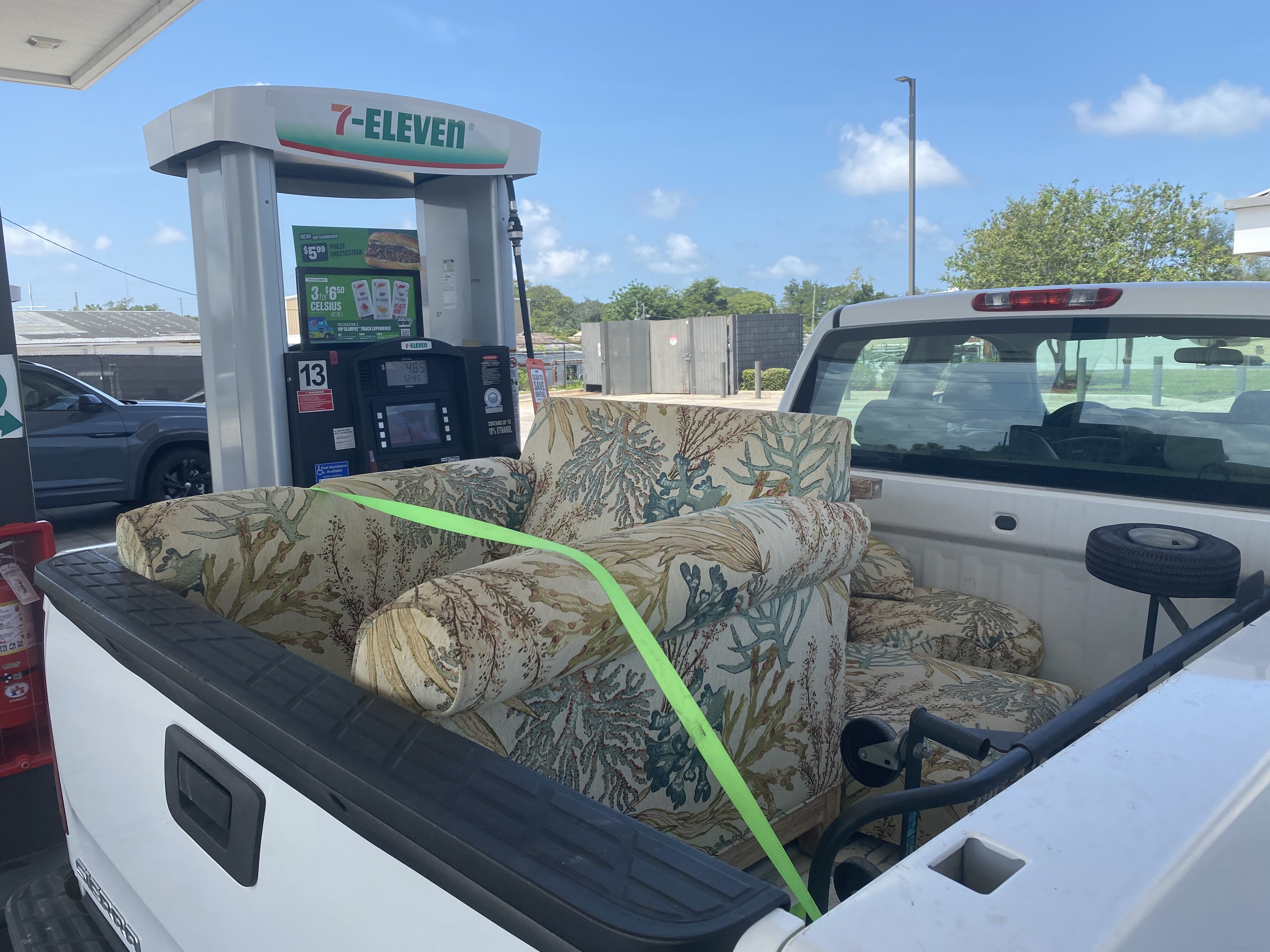 Sofa strapped into a pickup truck bed for furniture removal